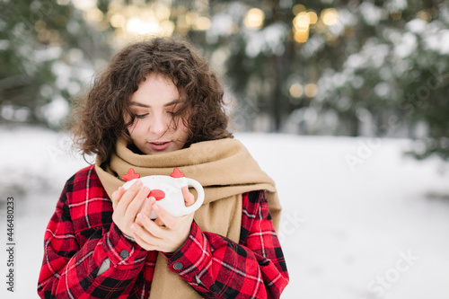 Happy Girl In Red Jachet The Snow Forest. Cold Winter. Cup of tea. photo