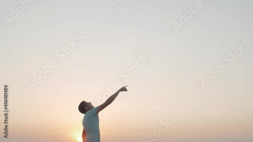 Wallpaper Mural man in cheerful mood throwing paper airplane in field on sunset on background of clear sky, concept of active rest outdoors and relaxation, toy of childhood Torontodigital.ca