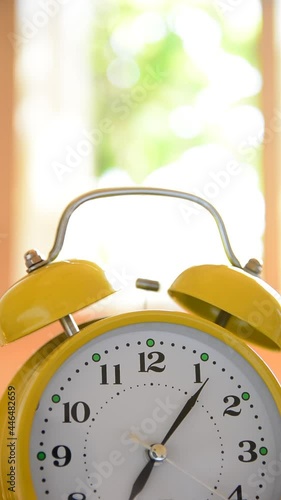 Close up of old clock with bells ringing on a desk at home in the morning. Copy space for design. The vertical position of the video