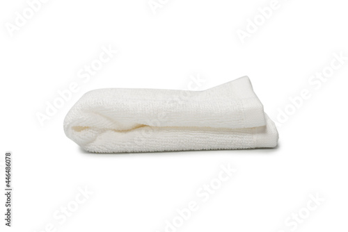 White fluffy cotton towel isolated on a white background.