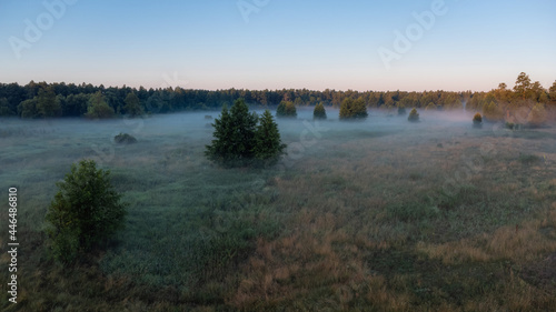 Foggy landscape of the valley during the sunrise. Beautiful bright morning time in the countryside