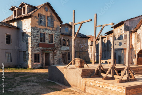 A yard and gallows in front of 18th century houses against a sky in the piligrim porto by spring day photo