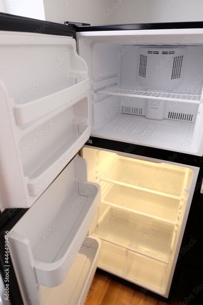 Empty fridge interior, selective focus. Clean refrigerator and freezer shelves close up. It is called Empty fridge interior, selective focus. Clean refrigerator and freezer shelves close up. It is called