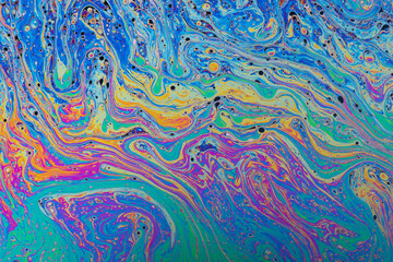 Fluid soap bubble psychedelic colorful abstract art. Surreal patterns with rainbows and waves of color in motion.