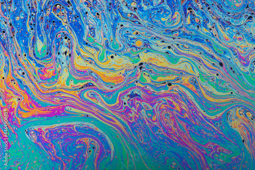 Fluid soap bubble psychedelic colorful abstract art. Surreal patterns with rainbows and waves of color in motion. photo