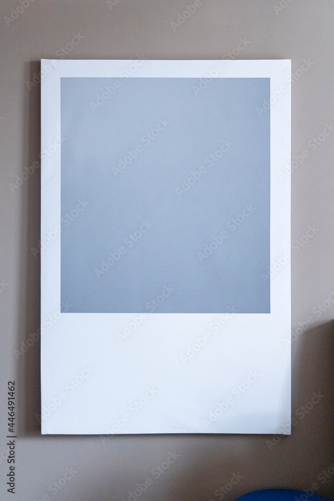 Modern house decoration, empty square frame, poster, white canvas, mock up, on a gray wall, bedroom, template front angle view Modern house decoration, empty square frame, poster, white canvas, mock up, on a gray wall, bedroom, template front angle view