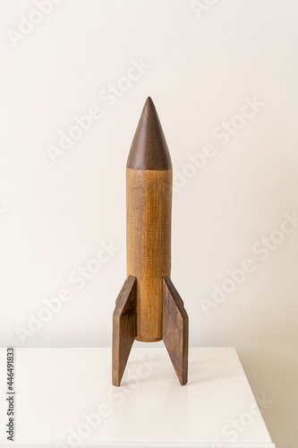 Interior kids bedroom design, wooden rocket, vintage skyrocket toy, residence nursery decor, old plaything