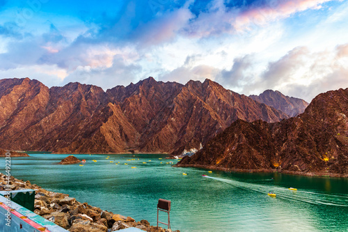 Beautiful view of Hatta Dam or Lake and Hajar Mountain in the Emirate of Dubai, UAE at sunset photo