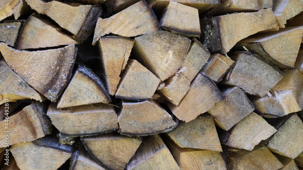 Neatly folded laying the wood. The wood texture of split wood. The problem of renewable energy sources. A lot of wood neatly stacked in a woodpile. Camera pan Neatly folded laying the wood. The wood texture of split wood. The problem of renewable energy sources. A lot of wood neatly stacked in a woodpile. Camera pan