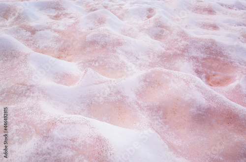 White and pink melted snow interspersed with red lies bumps