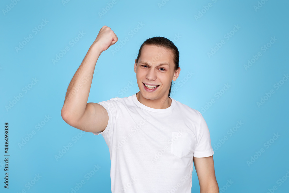 young handsome man in t-shirt showing victory gesture young handsome man in t-shirt showing victory gesture