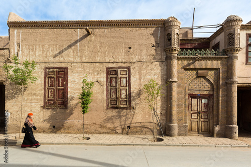 Photography Chinese muslim uighur veiled woman passing in front of a mosque in kashgar, Xinj