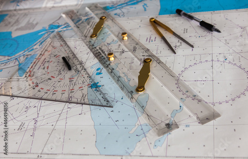 Maps of the ship for plotting. Plotter, divider, ruler and pen. Close-up.