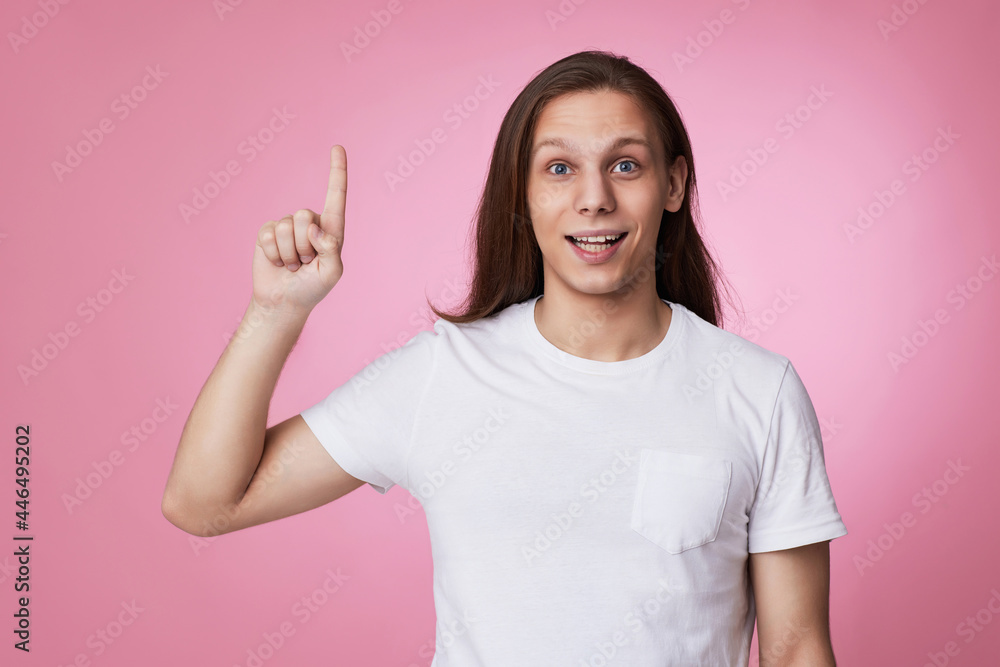 young man pointing finger away at empty space young man pointing finger away at empty space