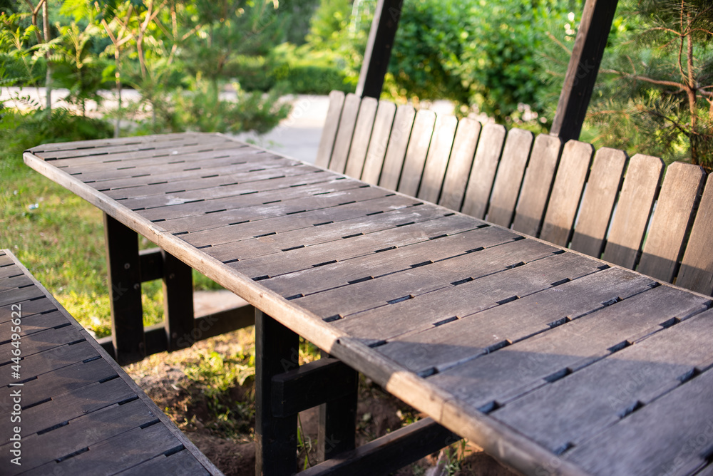 gray wooden table in the park