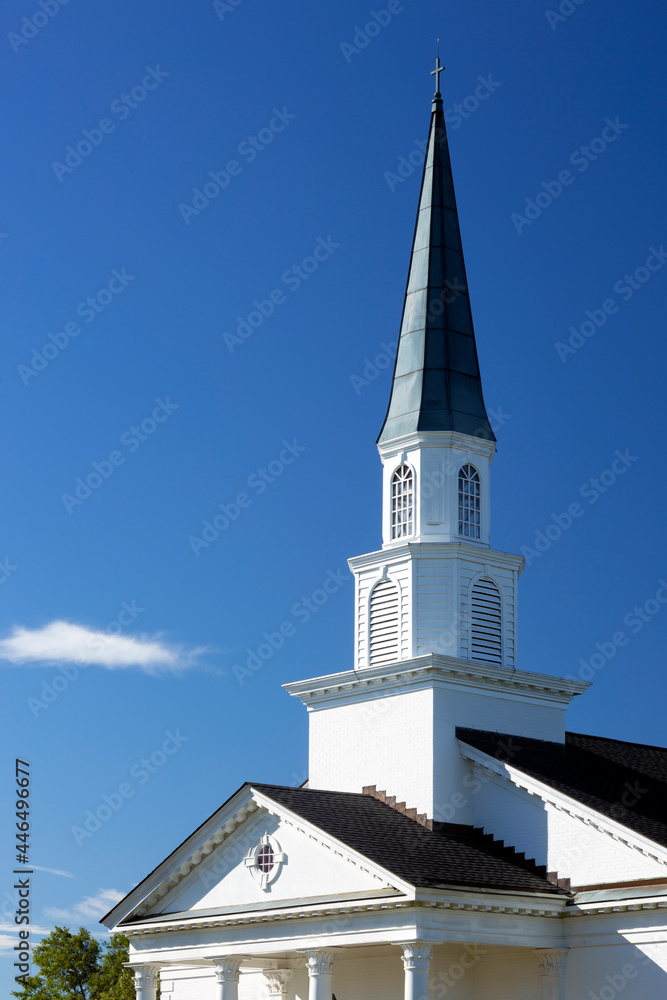 Closeup of white church steeple with blue sky Closeup of white church steeple with blue sky