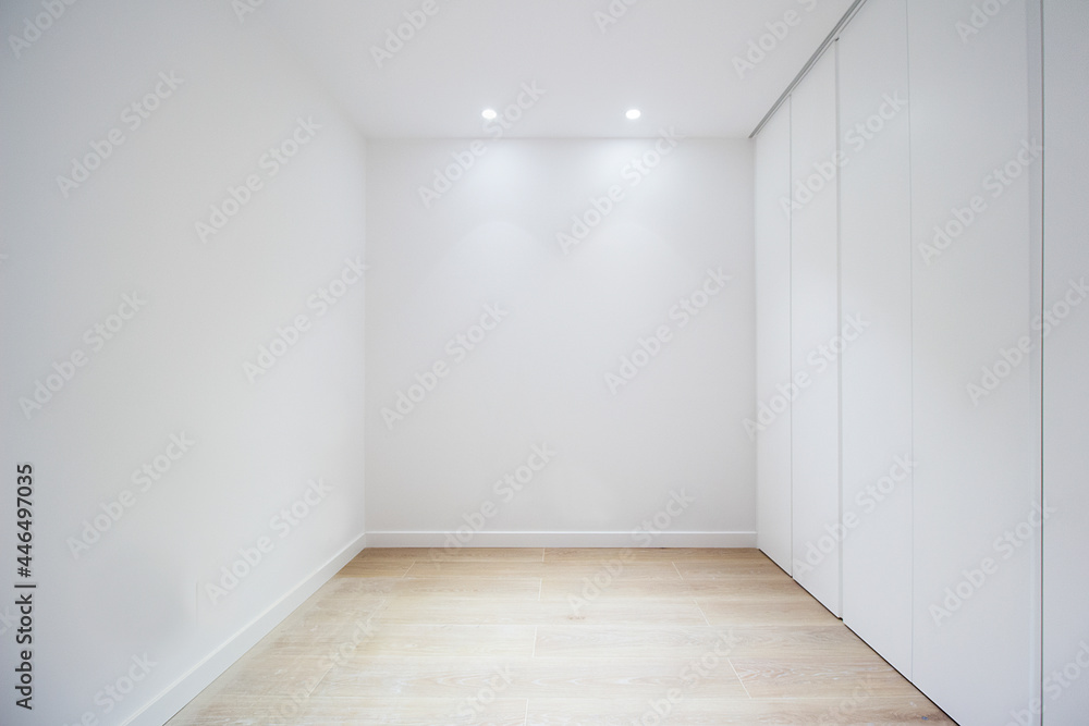 empty room with door closets and white walls empty room with door closets and white walls