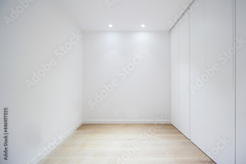empty room with door closets and white walls