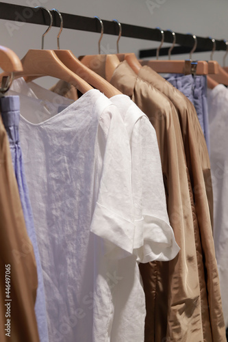 summer clothes in tent with wooden hangers