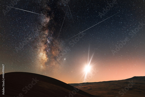 Beautiful bright milkyway galaxy and moon above the hill. Starry sky, night landscpe.  photo