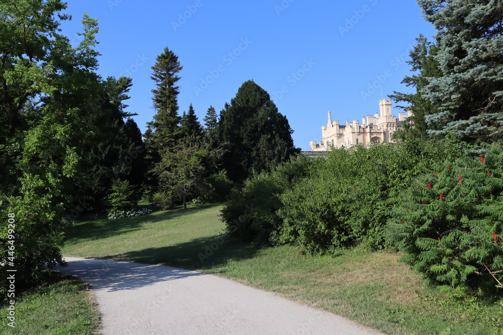 A path leading through the castle garden with a view of Lednice castle. Czech history. Lednice-Valtice area in the Czech Republic.