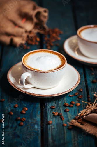 Cups of coffee on a rustic wooden background
