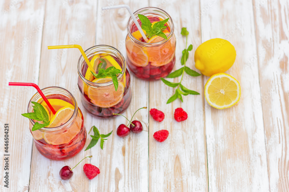 a drink made from lemon, strawberry, raspberry, cherry and mint. detox water. fruity citrus summer refreshing cocktail a drink made from lemon, strawberry, raspberry, cherry and mint. detox water. fruity citrus summer refreshing cocktail
