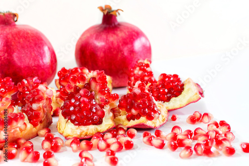 Ripe pomegranate fruit isolated on white background cutout.