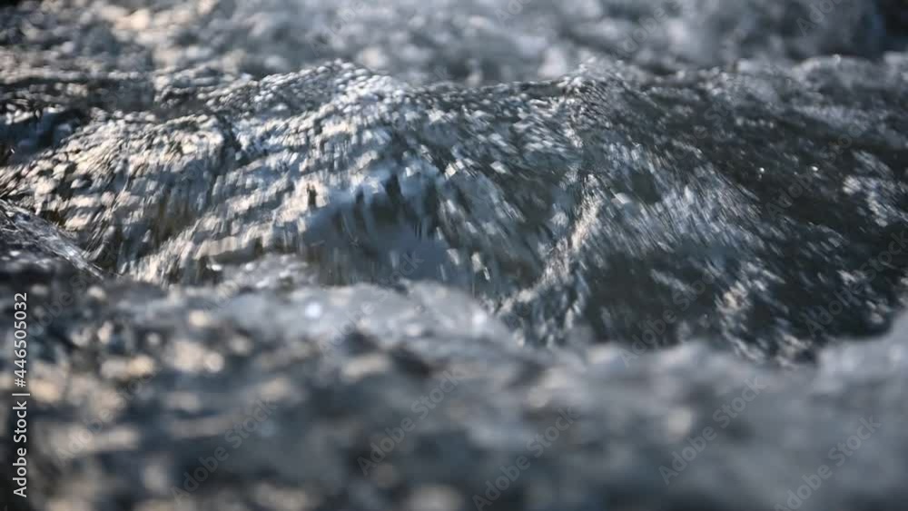 Slow motion of wild clear mountain river , stream flowing through rocks. Close up of river stones with flowing water, clean water flowing in a mountain river Slow motion of wild clear mountain river , stream flowing through rocks. Close up of river stones with flowing water, clean water flowing in a mountain river
