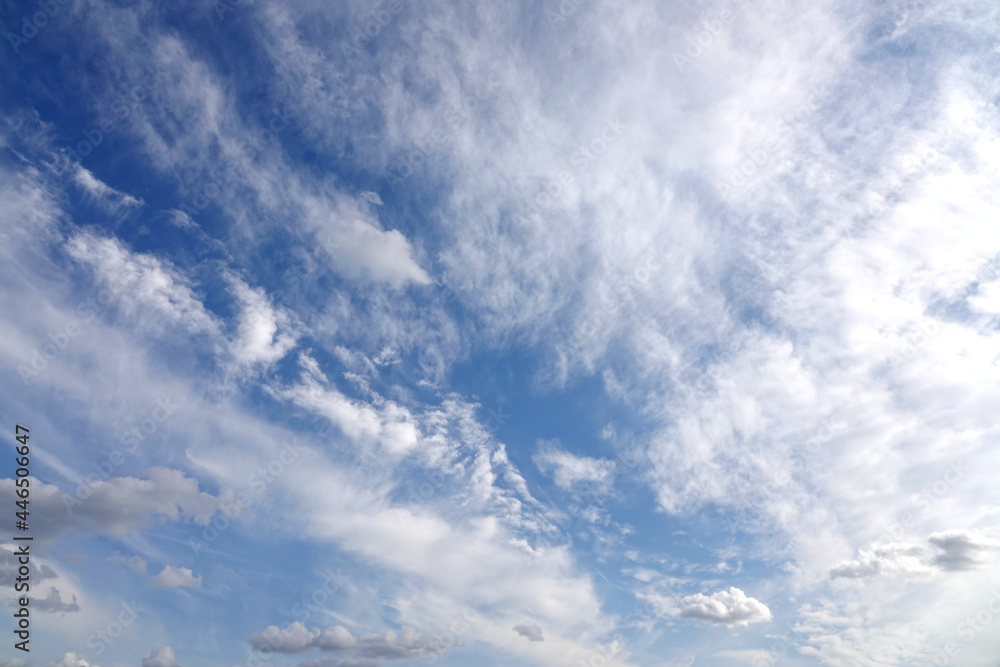 Beautiful heaven landscape with dense stormy white and gray clouds on different levels and some blue sky horizontal photo