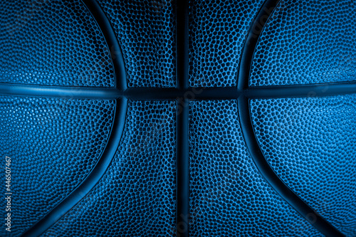 Closeup detail of basketball ball texture background. Blue neon Banner Art concept © Augustas Cetkauskas