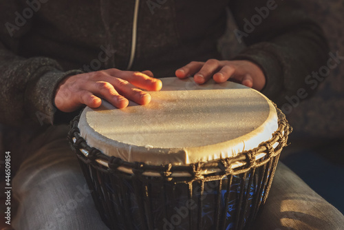 The drummer plays the ethnic percussion musical instrument djembe