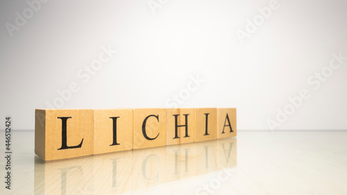 The name Lichia was created from wooden letter cubes. Seafood and food. photo