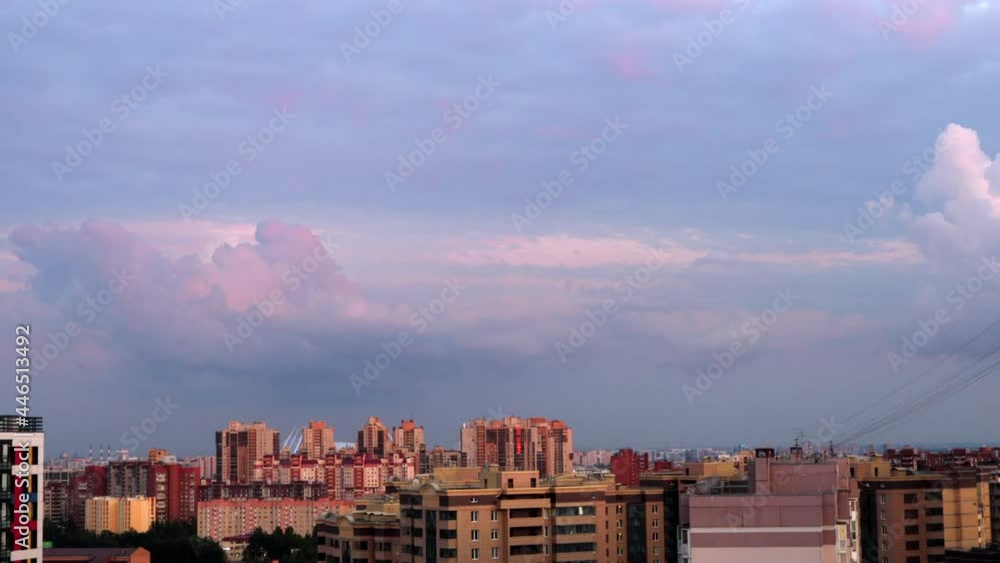 Clouds over the city in the evening. Timelapse of purple and pink clouds in the sky Clouds over the city in the evening. Timelapse of purple and pink clouds in the sky