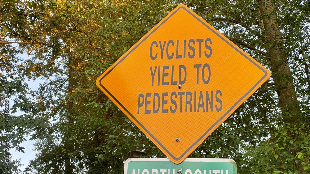 sign on the road Cyclist yelled to pedestrians sign on the road Cyclist yelled to pedestrians