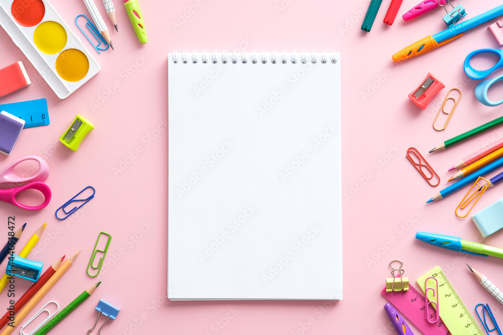 School stationery and blank paper notebook on pink background. School and office supplies. Back to school concept. Flat lay, top view, copy space. School stationery and blank paper notebook on pink background. School and office supplies. Back to school concept. Flat lay, top view, copy space.
