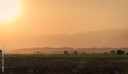 Sunset over fields and hills