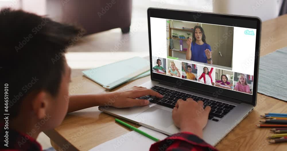 Schoolboy using laptop for online lesson at home, with diverse teacher and class on screen Schoolboy using laptop for online lesson at home, with diverse teacher and class on screen