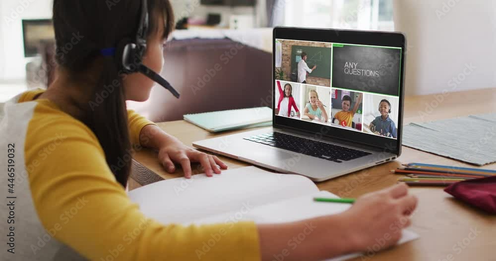 Schoolgirl using laptop for online lesson at home, with diverse teacher and class on screen