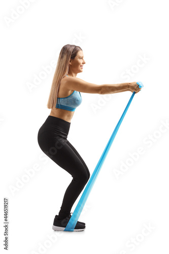 Young woman exercising with an elastic rubber band