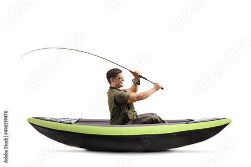 Fisherman throwing a fishing rod from a canoe