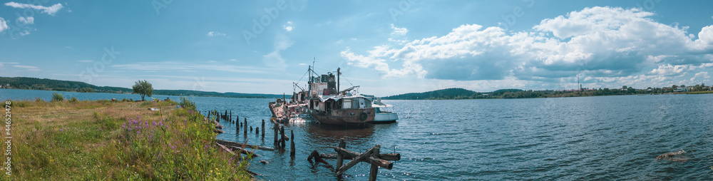 Abandoned ship in the bay on a summer day panorama