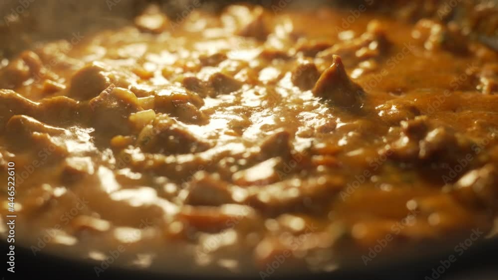 Close up of stewing beef and vegetables goulash in a pan. Concept of cooking tasty food. Close up of stewing beef and vegetables goulash in a pan. Concept of cooking tasty food.