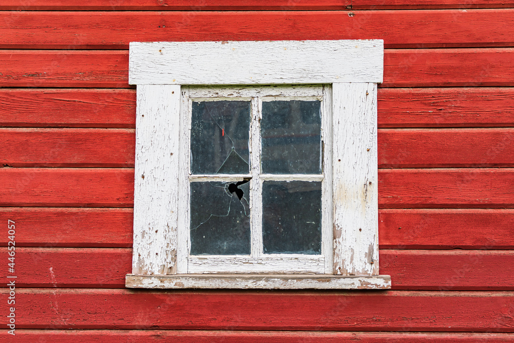 White framed window in a red barn. White framed window in a red barn.