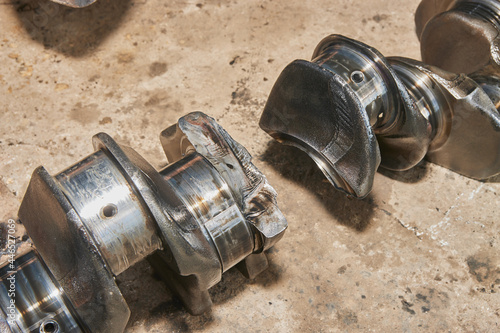 Fractured Crankshaft with Engine Oil Stain of Truck Engine on Concrete Floor
