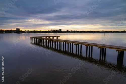 The sun rises over a dock in the river in Florida © Jeff Whiting