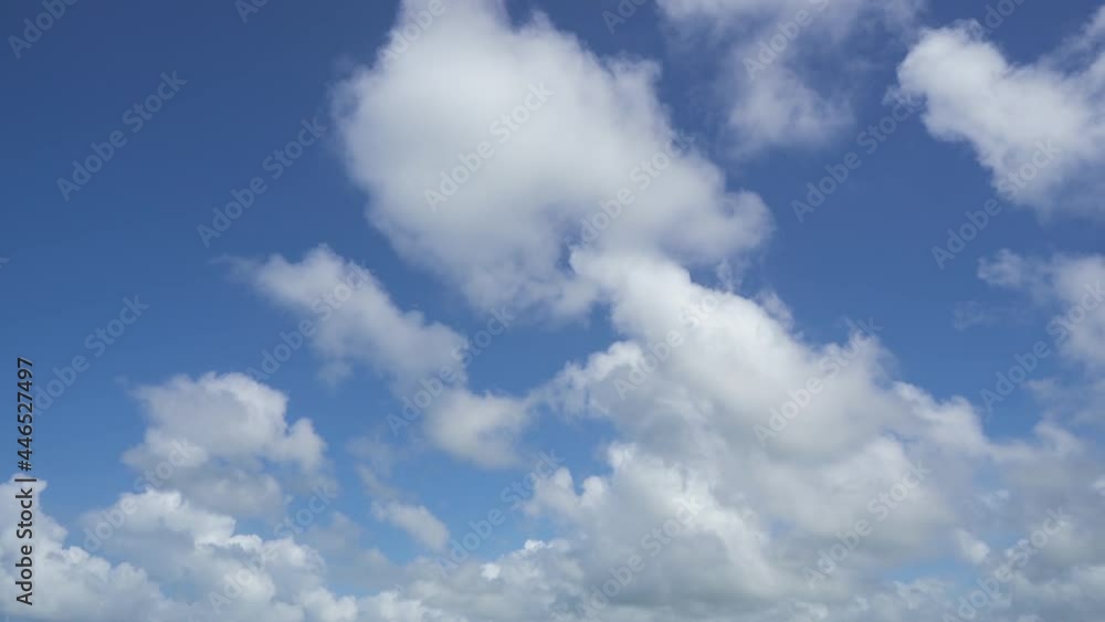 Bright white fluffy clouds fly in the blue sky on a sunny day. Bright white fluffy clouds fly in the blue sky on a sunny day.