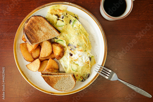 Vegetarian omelette with toast and potatoes
