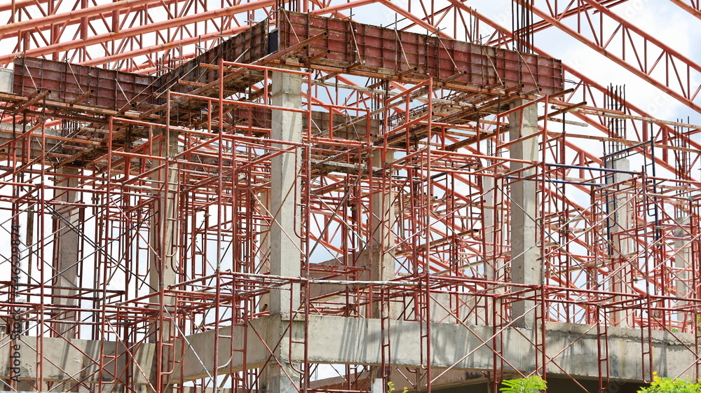 Scaffolding metal prop. Red iron is a props to support formwork slabs on a construction site. select focus Scaffolding metal prop. Red iron is a props to support formwork slabs on a construction site. select focus