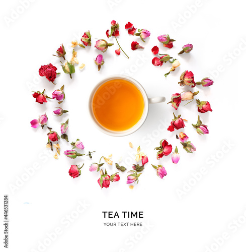 Creative layout made of cup of tea with flowers around on a white background. Top view. 